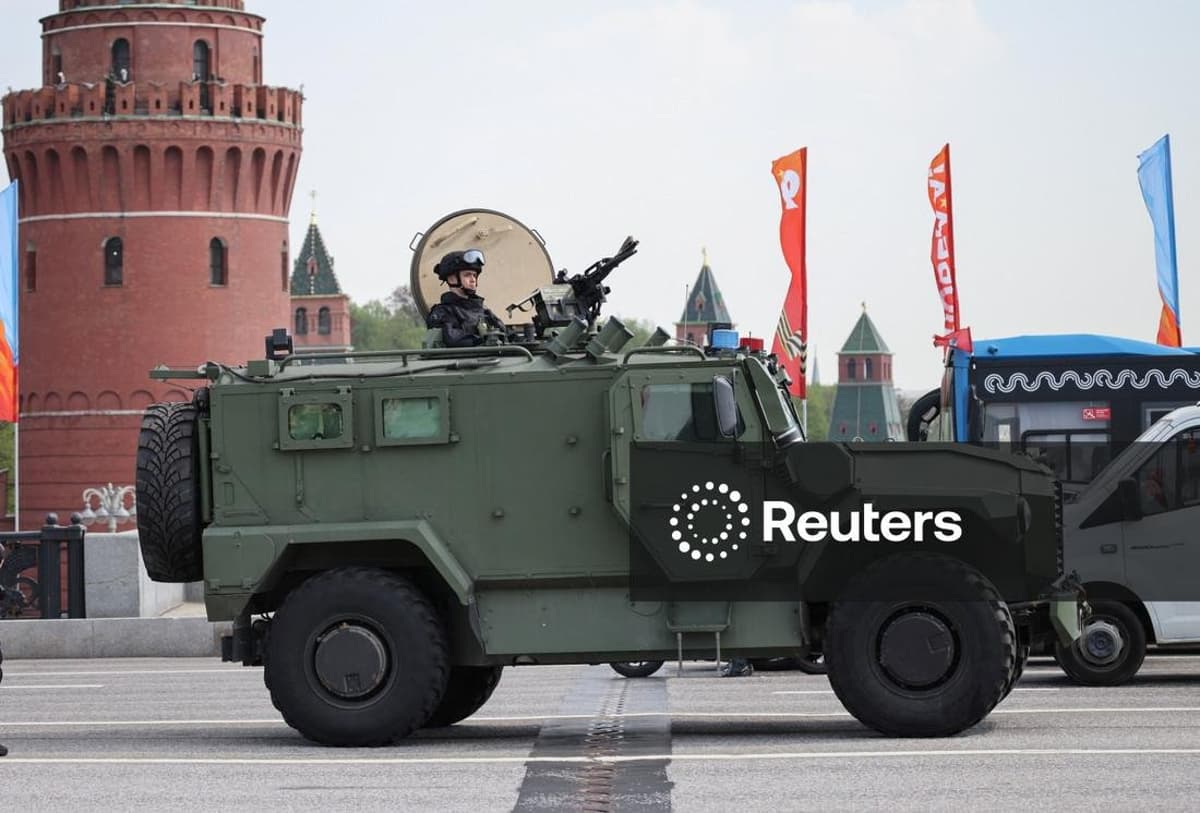 Security Officer Perches on Vehicle Ahead of Victory Day
