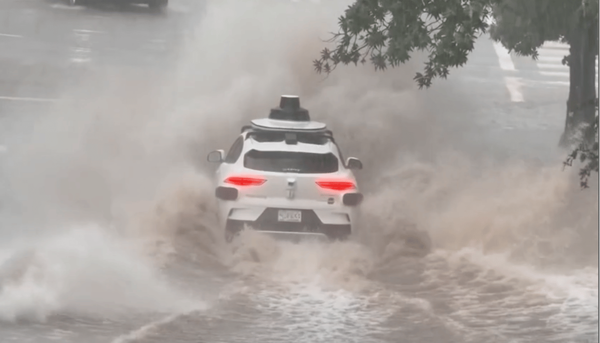 Waymo Driving Through a Flooded Street in Dallas
