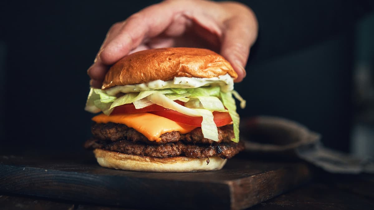 Something Magically Flavorful Happens To Burger Patties When You Add This