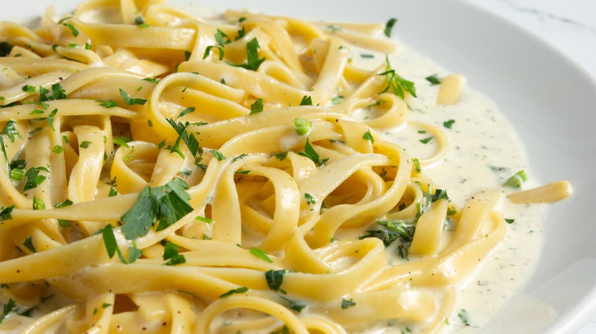 The Cheesy (And Lazy) Mistake That Ruins Homemade Alfredo Sauce