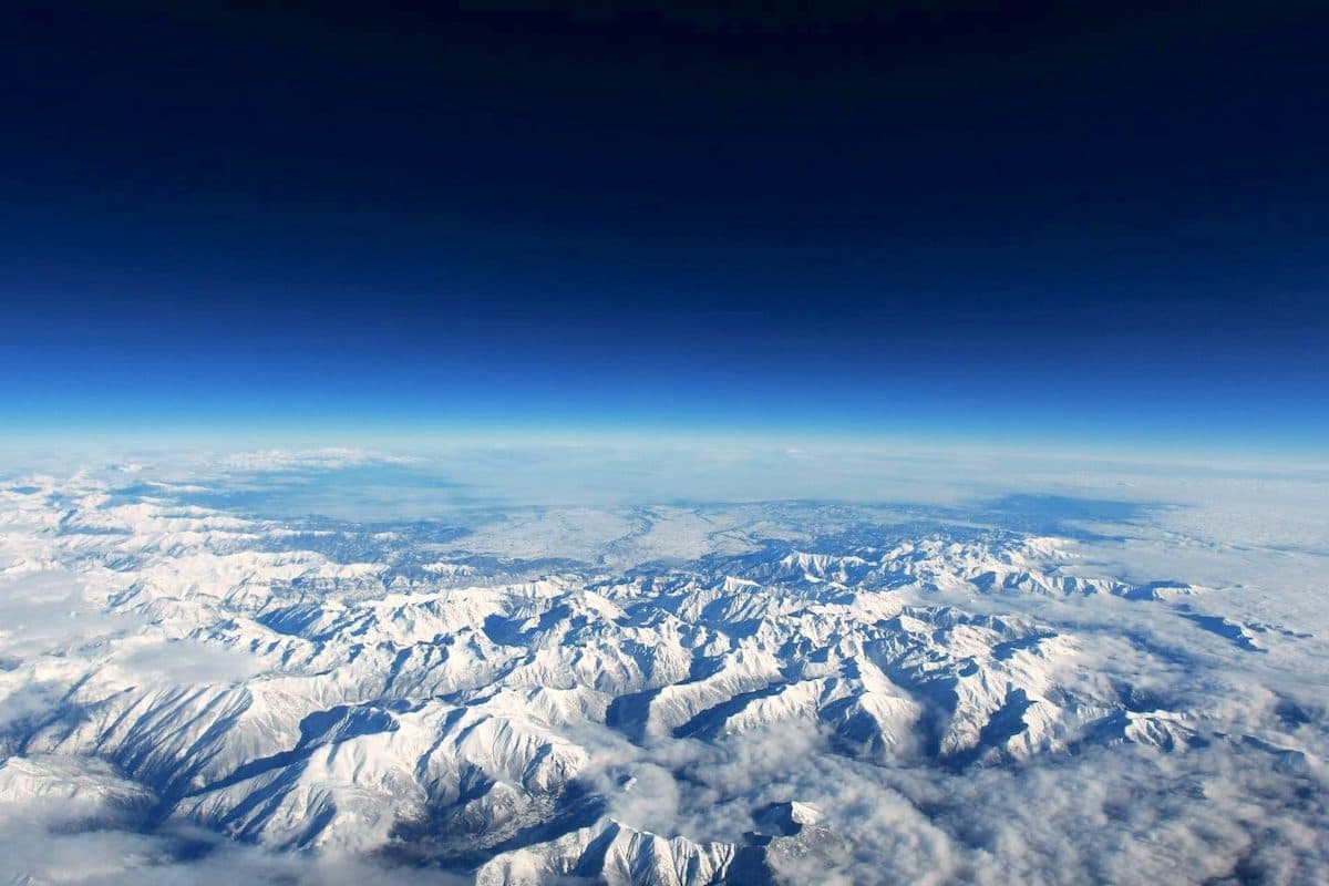As the Planet Warms, Why Is the Upper Atmosphere Cooling?